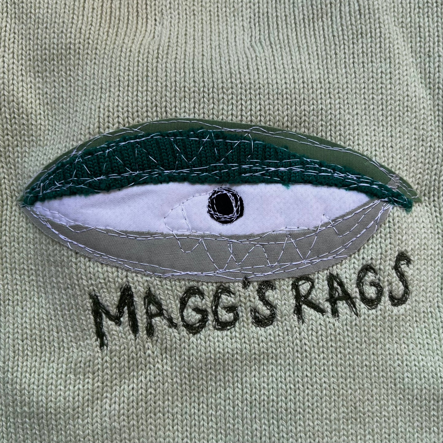Green eyeball sweater